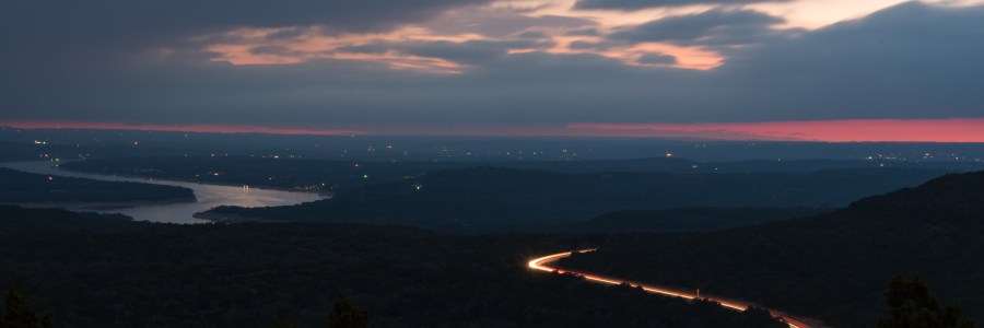 Long exposure clouds and highway lake travis