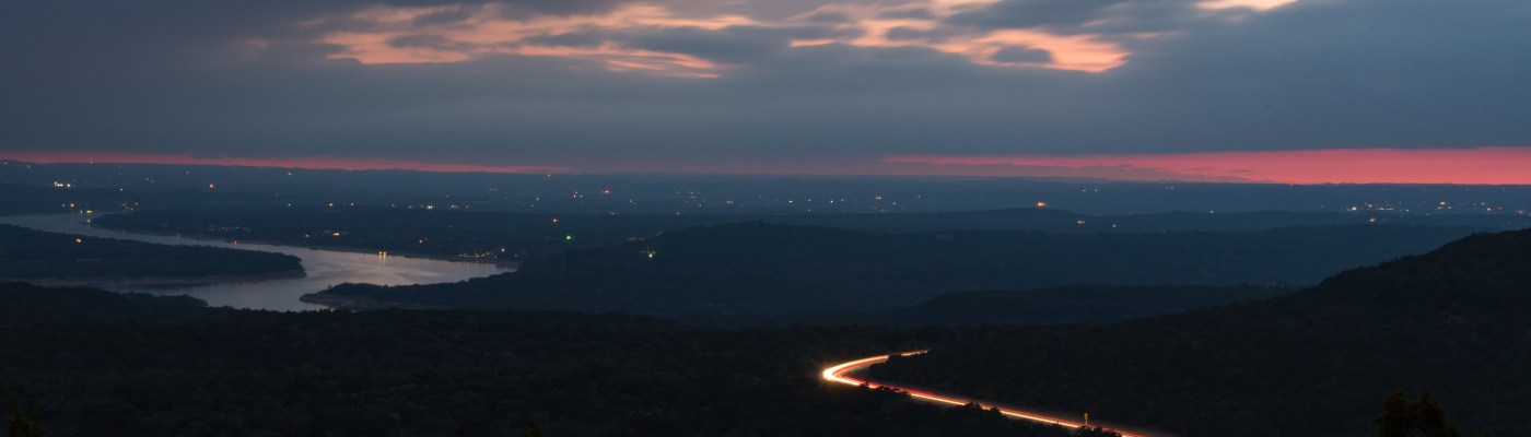 Long exposure clouds and highway lake travis