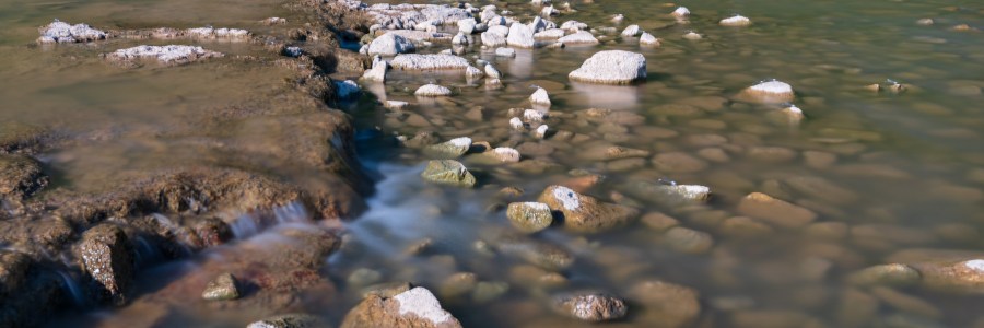 Long exposure of water rushing over rocks in the Colorado river Texas