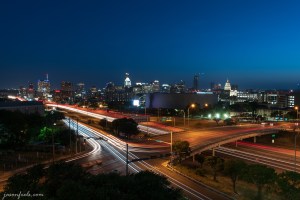 Austin Texas skyline at night with car light trails on IH35