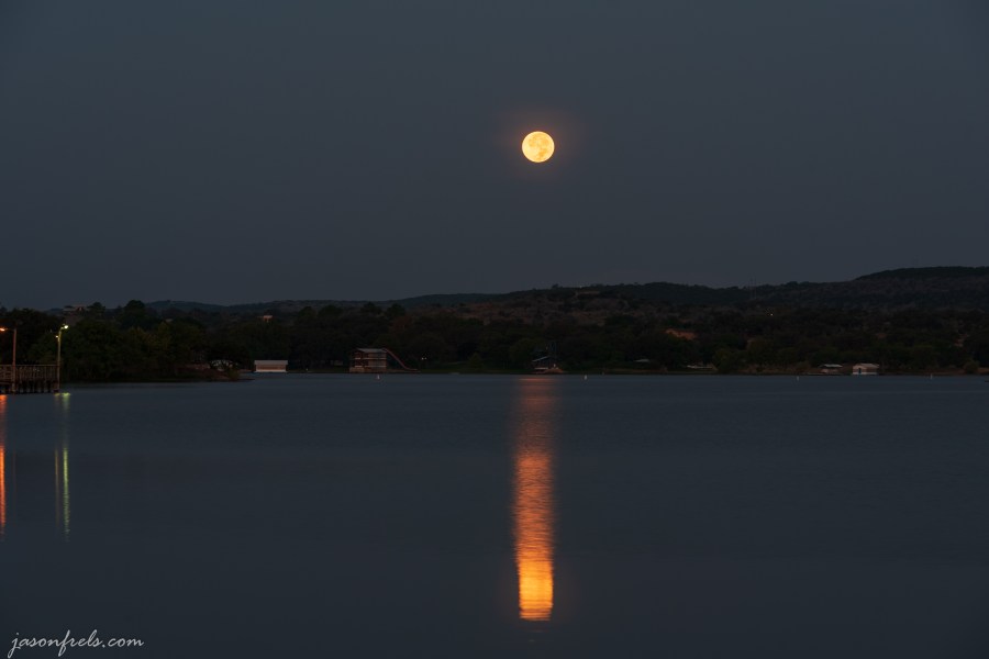 Full moon setting over Inks Lake Texas just before dawn