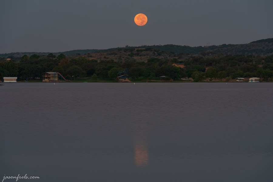 Full moon setting over Inks Lake Texas just before dawn