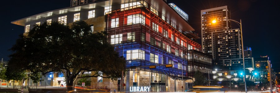Austin Central Libary at night in color with blurred car lights