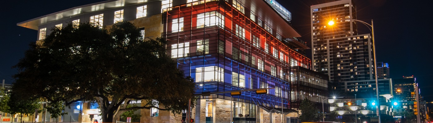 Austin Central Libary at night in color with blurred car lights